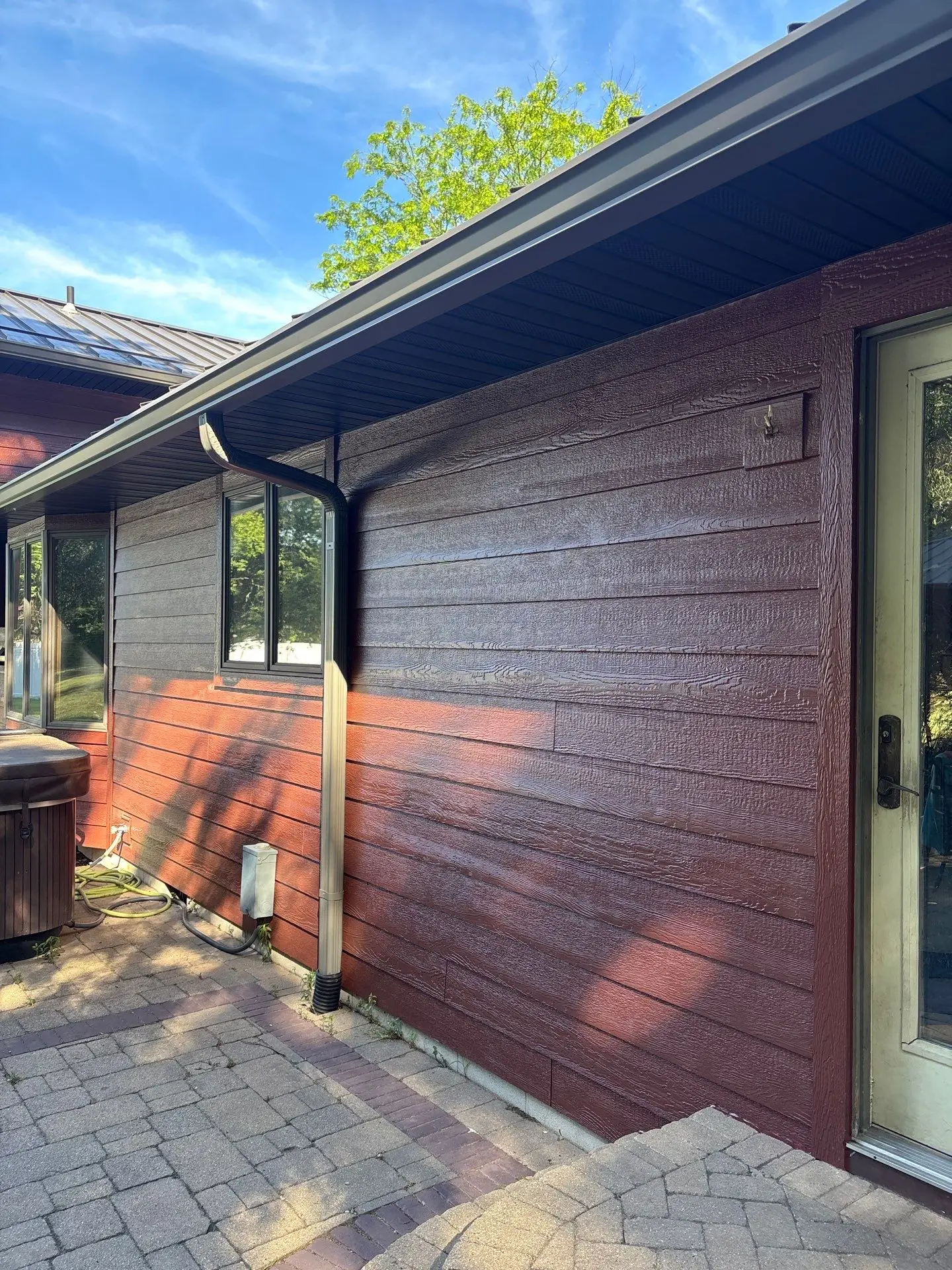 Siding installation with seamless gutters on a residential home exterior in Northwest Indiana.