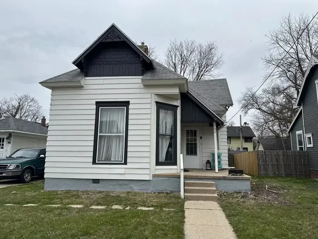 Historic home before roof and siding replacement, showing aging exterior materials prior to renovation.