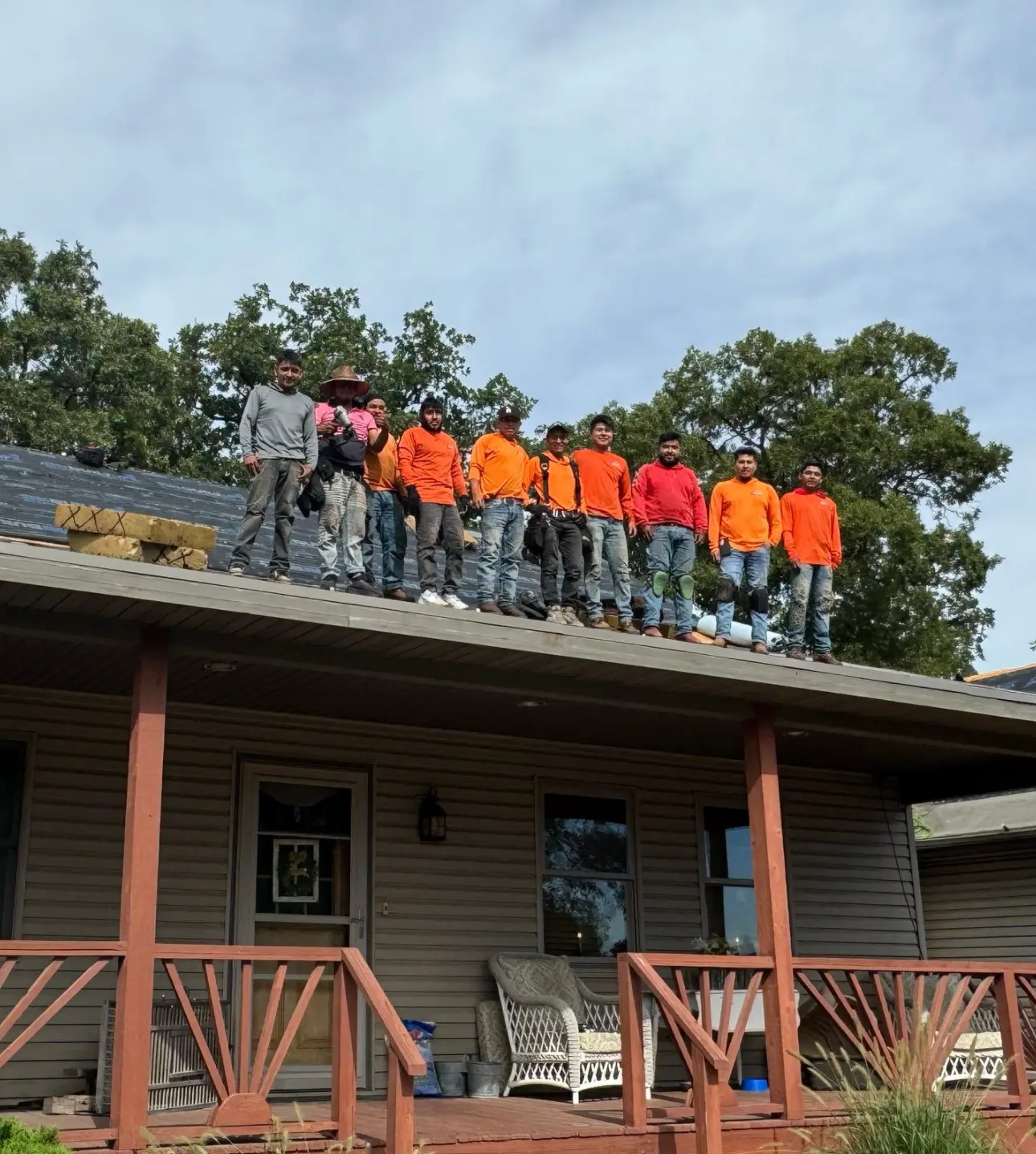 Quad County Roofing crew standing on a residential roof during a professional roof replacement project.